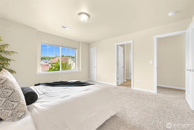 a bedroom with a bed and a window