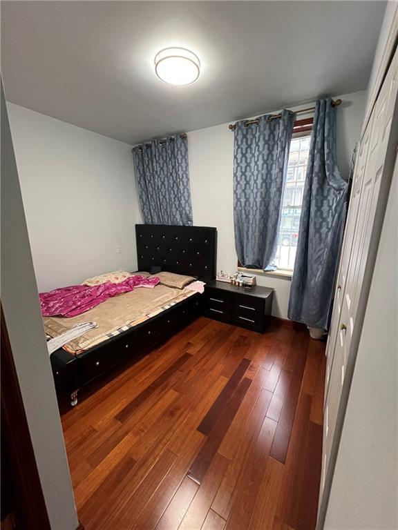 6710 13th Avenue Brooklyn, NY 11219 - Photo 5 of 9 a bedroom with a bed and wooden floor