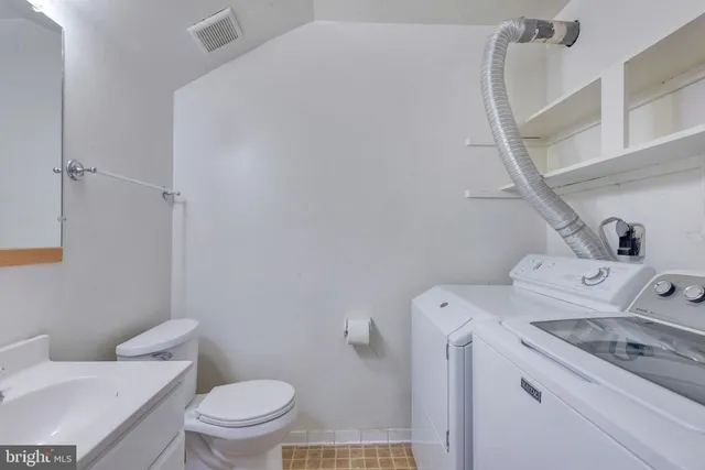 a view of bathroom with a washer and dryer