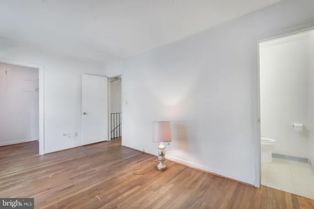 a view of an empty room and wooden floor