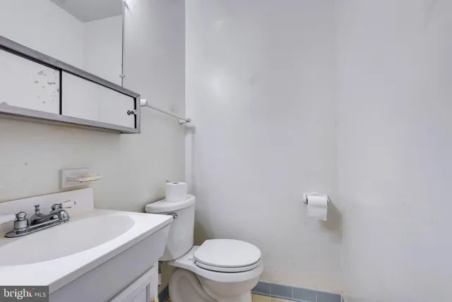 a bathroom with a sink a toilet and vanity