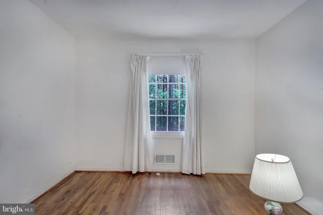 a view of room with hardwood floor and window