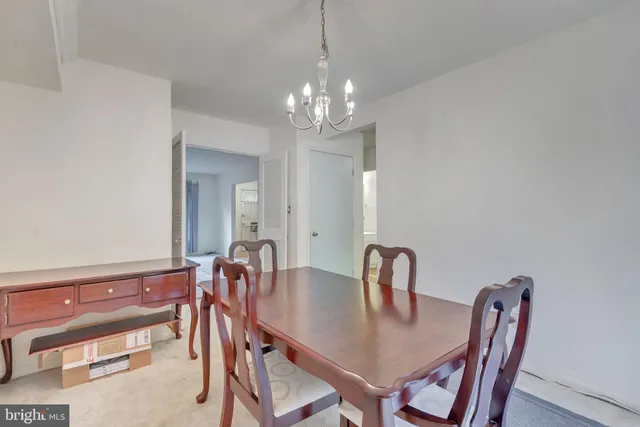 a view of a dining room with furniture and chandelier