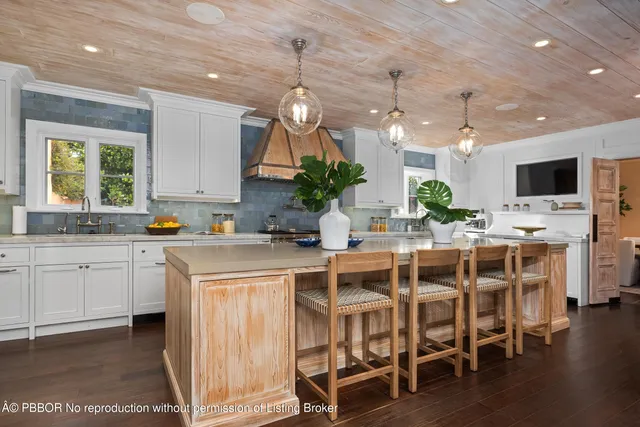 a kitchen with a table chairs sink and cabinets