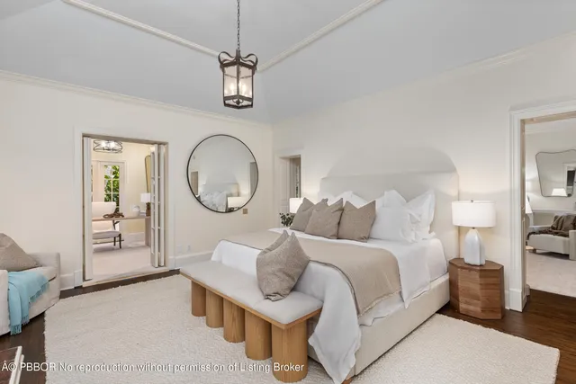 a bed room with a bed mirror and a window