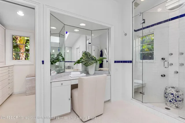 a bathroom with a granite countertop sink a mirror and a shower