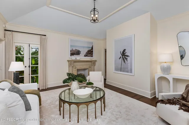 a living room with furniture and a mirror