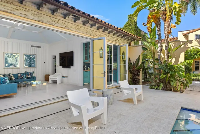 a building outdoor space with patio furniture and potted plants