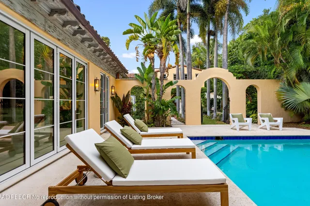 a swimming pool with outdoor seating