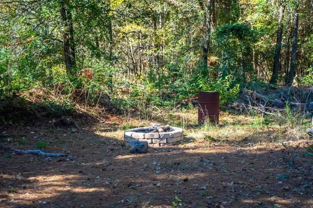 a backyard with table and chairs and potted plants