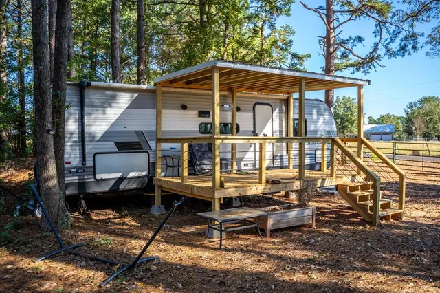 a view of a wooden chairs on the deck
