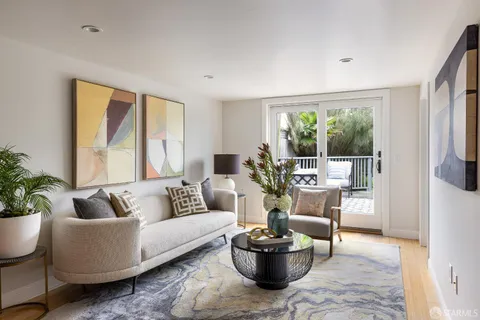 a living room with furniture and a potted plant