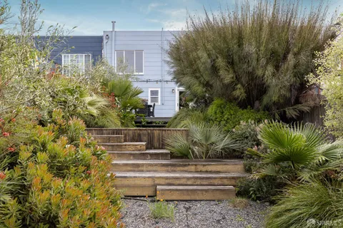 a view of a house with a yard and plants