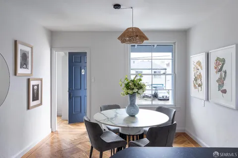 a view of a dining room with furniture window and wooden floor