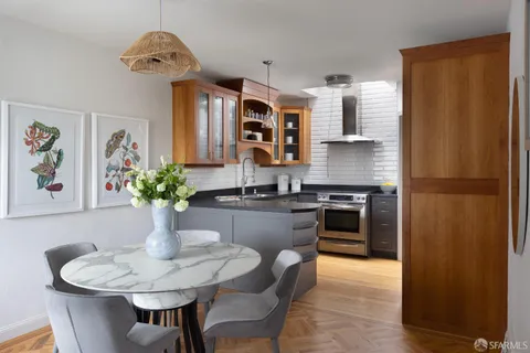 a kitchen with stainless steel appliances granite countertop a sink and a refrigerator