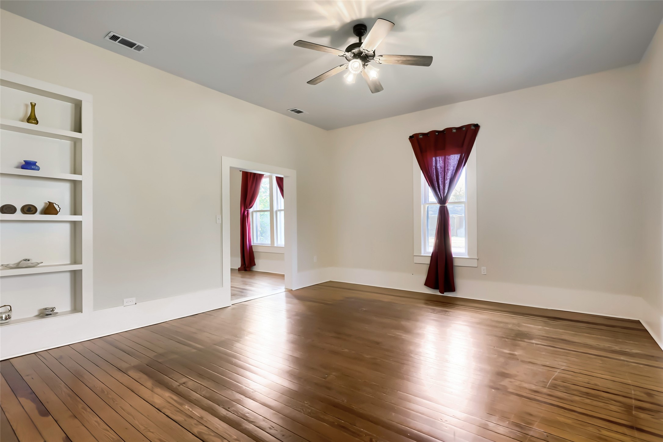 208 North Ave B Elgin, TX 78621 - Photo 11 of 29 a view of an empty room with wooden floor