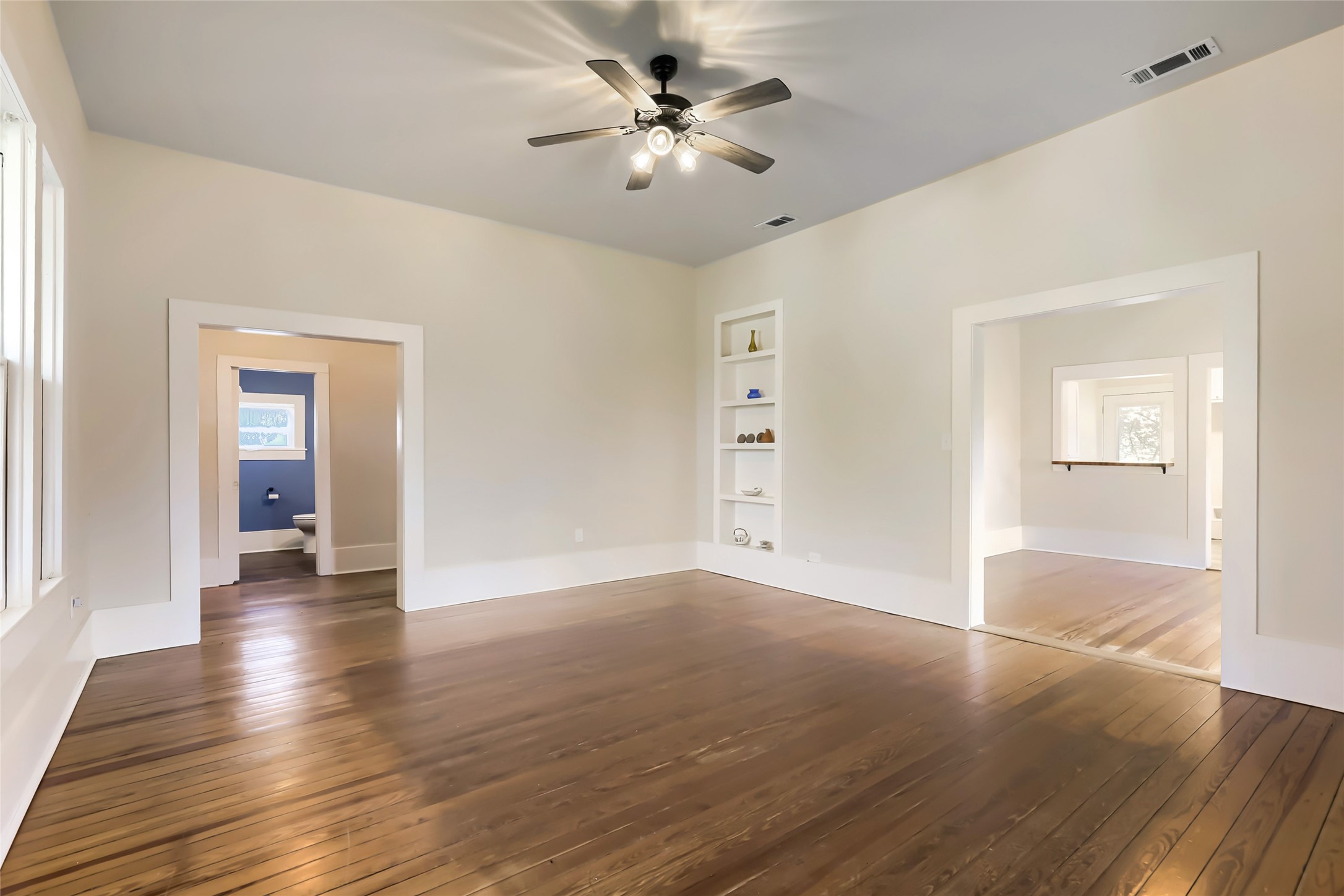 208 North Ave B Elgin, TX 78621 - Photo 12 of 29 a view of an empty room with window and wooden floor