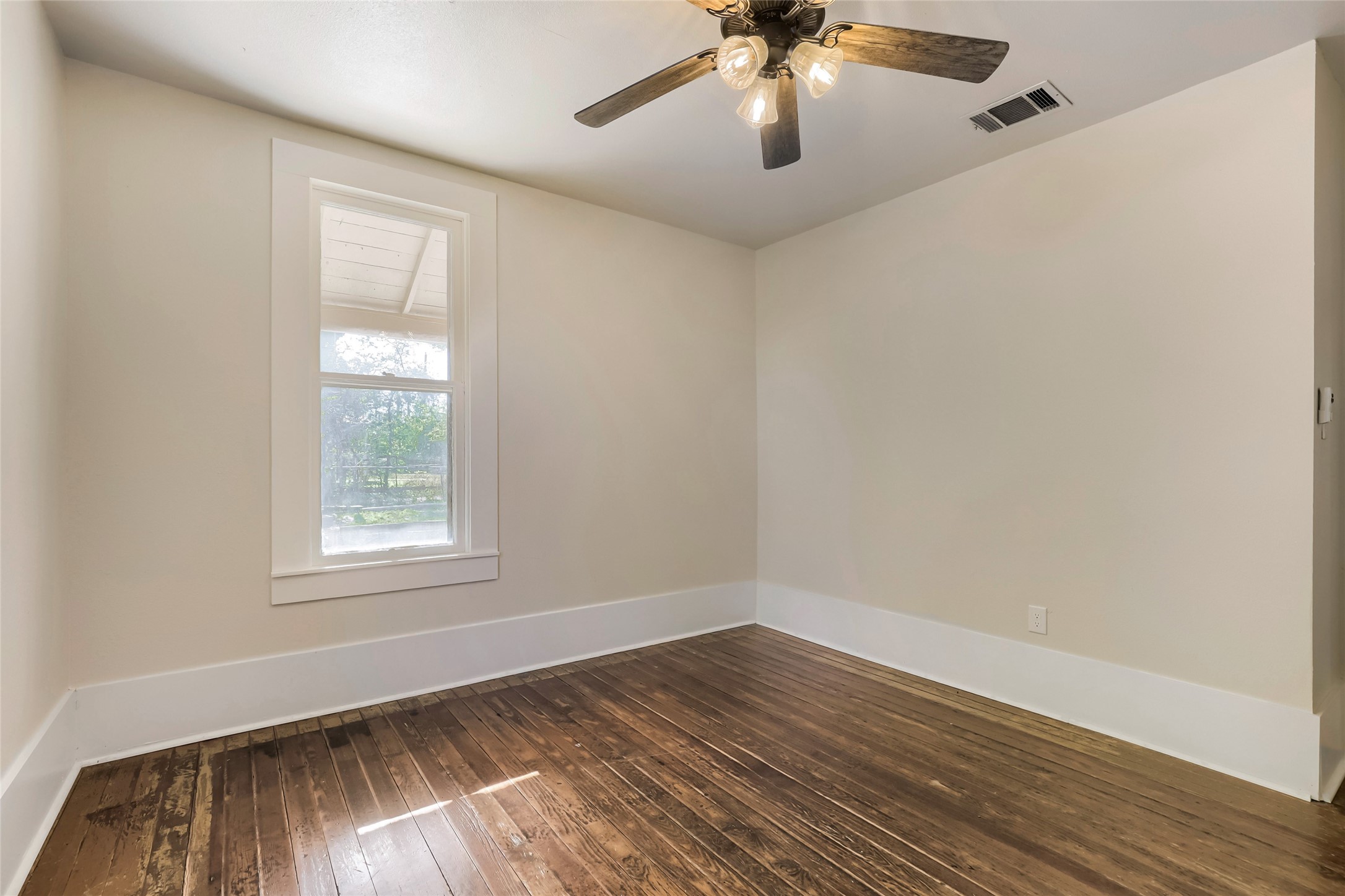 208 North Ave B Elgin, TX 78621 - Photo 19 of 29 wooden floor in an empty room with a window