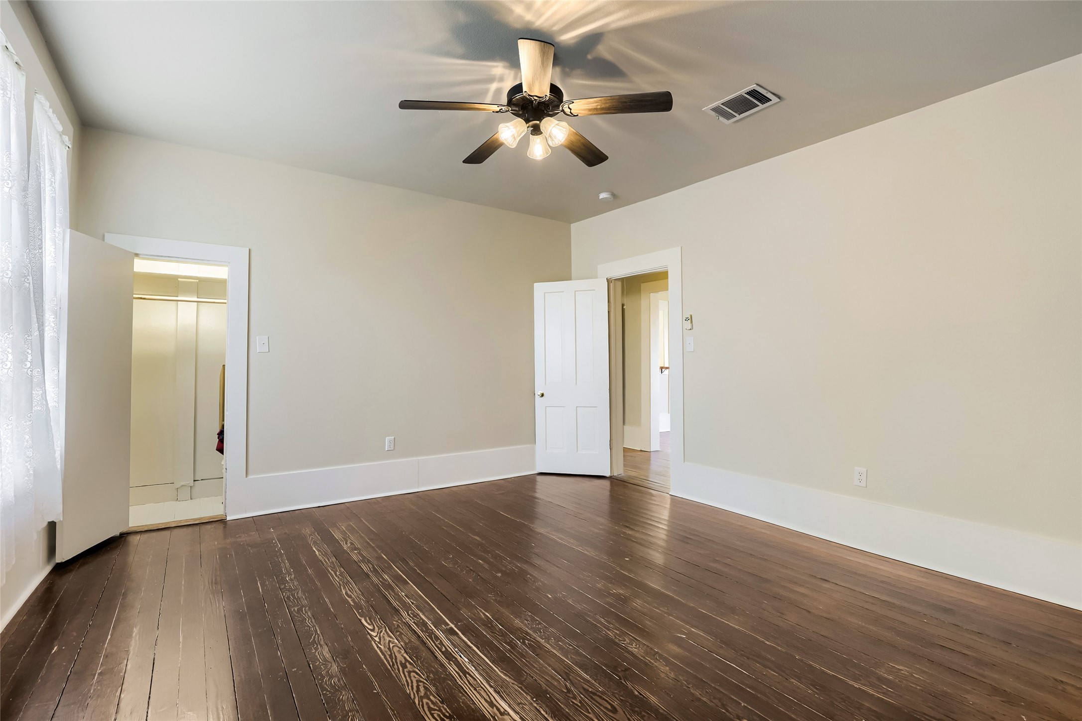 208 North Ave B Elgin, TX 78621 - Photo 22 of 29 a view of an empty room with wooden floor