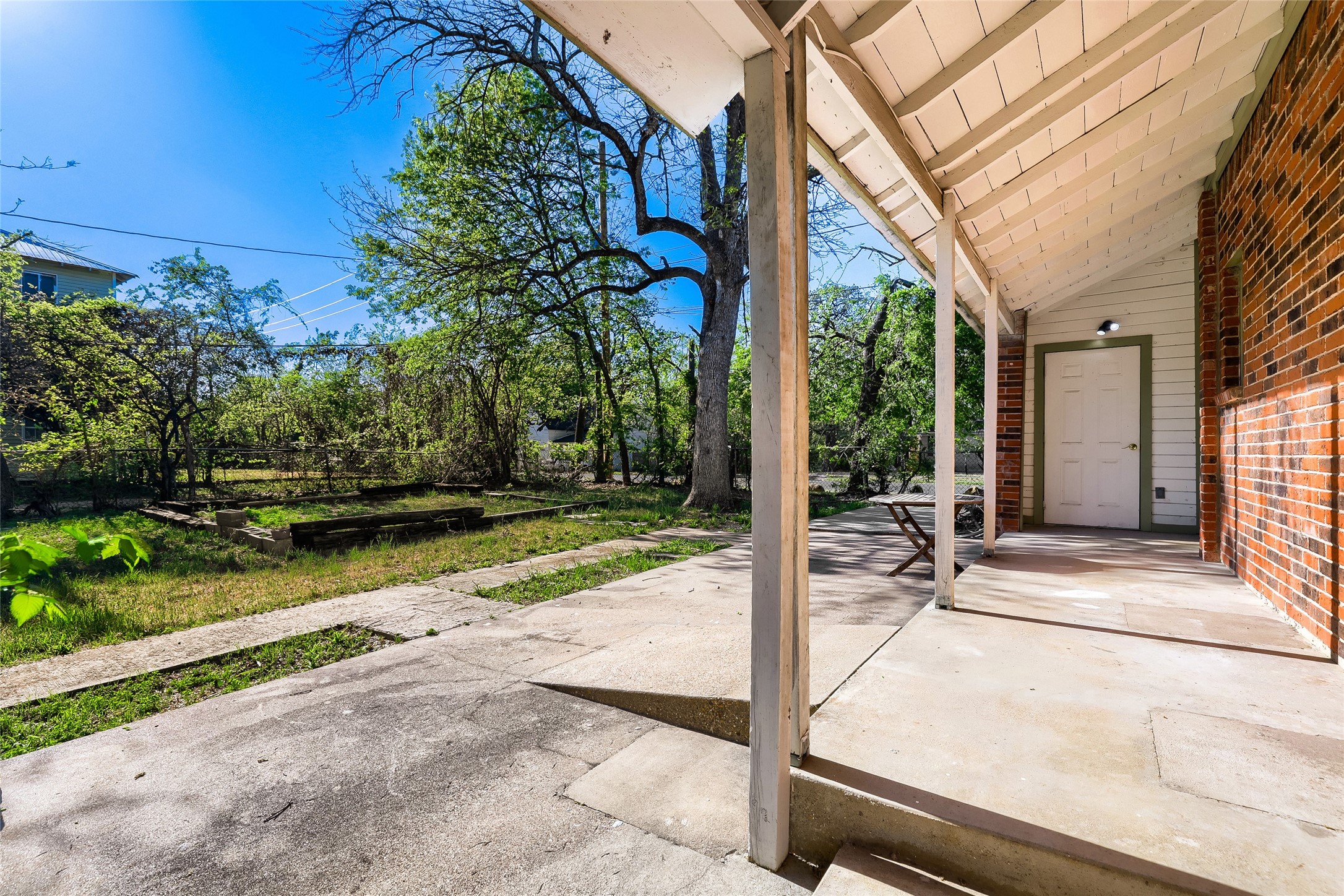 208 North Ave B Elgin, TX 78621 - Photo 28 of 29 a view of backyard with wheel chair potted plants and large tree