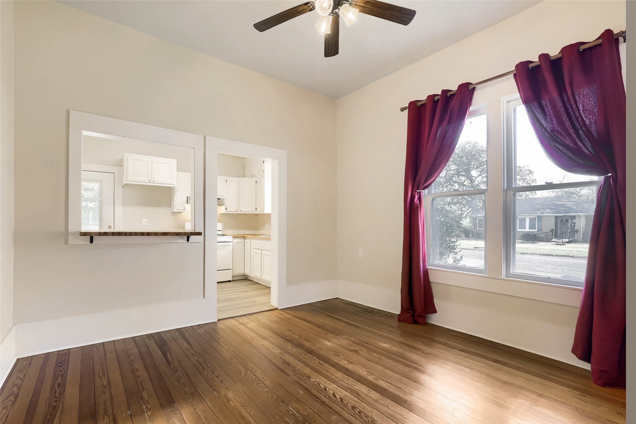 208 North Ave B Elgin, TX 78621 - Photo 6 of 29 a view of an empty room with wooden floor and a window