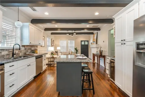 a kitchen with counter space a sink appliances and cabinets