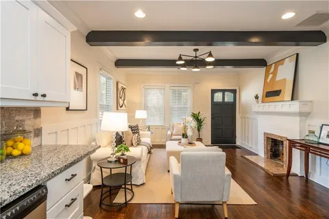 a living room with fireplace furniture and a wooden floor