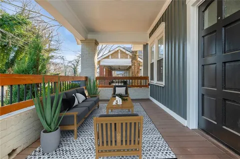 a view of a two chairs and table in the balcony