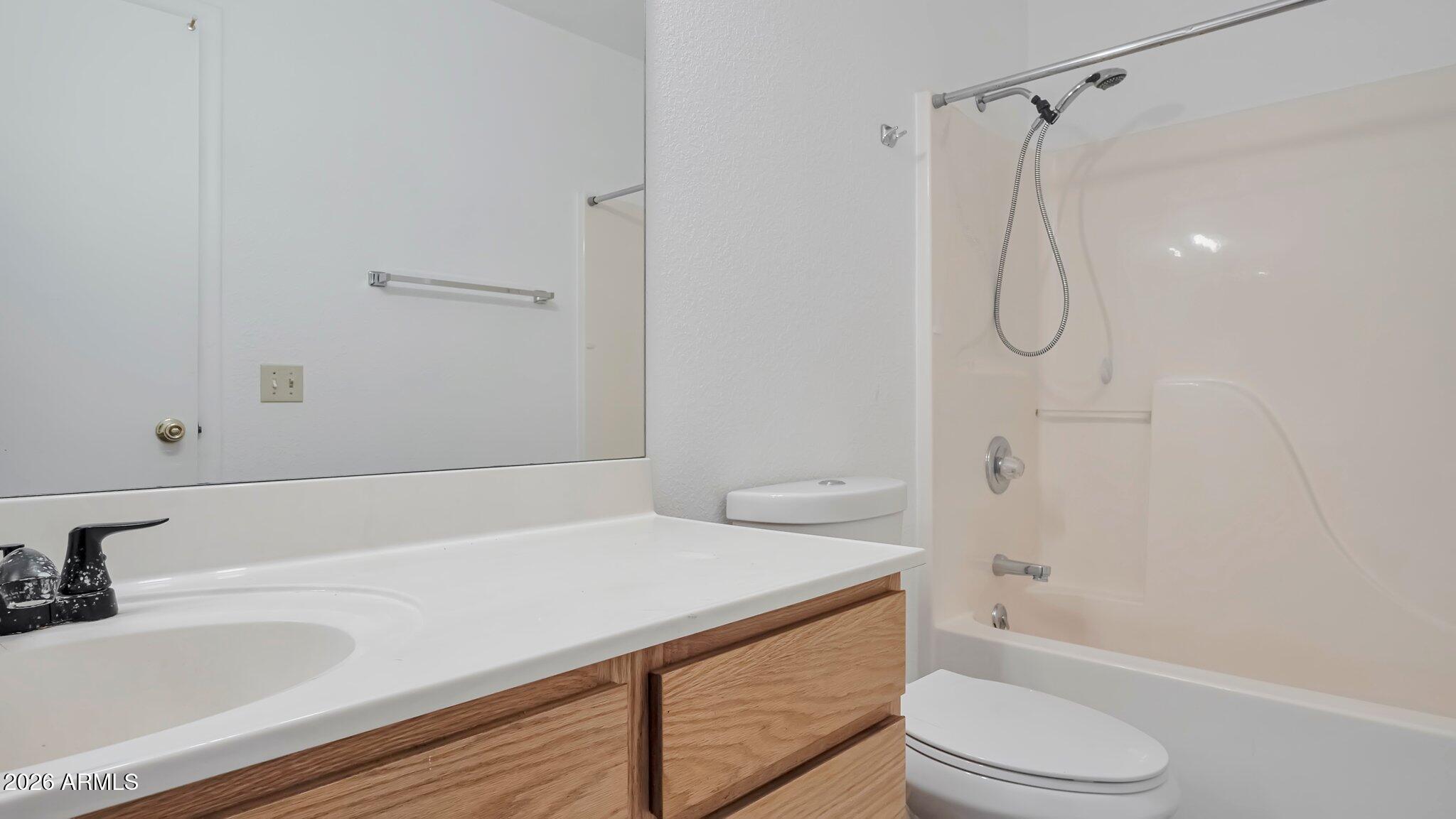 4125 North Pima Way Rimrock, AZ 86335 - Photo 8 of 14 a bathroom with a granite countertop sink toilet and shower