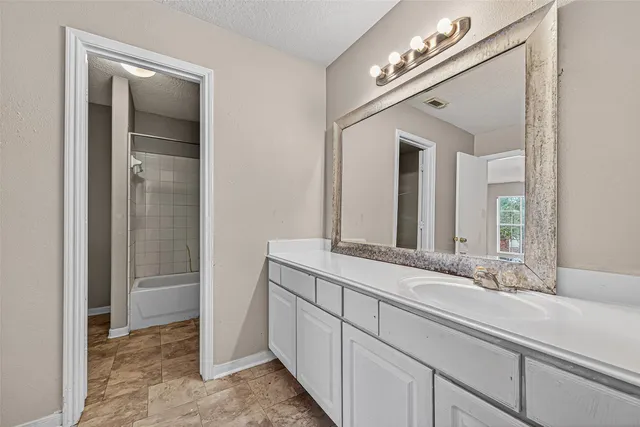 a bathroom with a bathtub and shower
