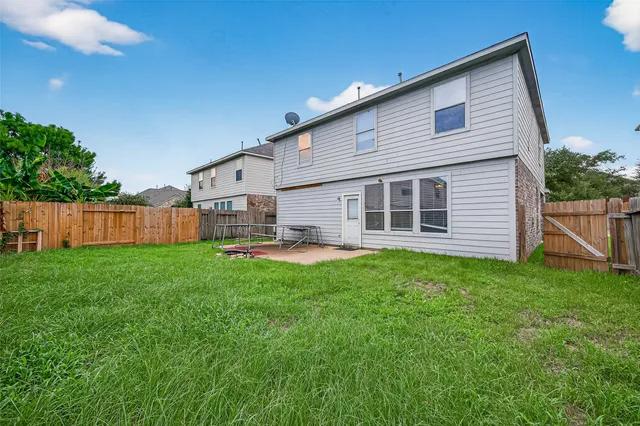 a backyard of a house with table and chairs