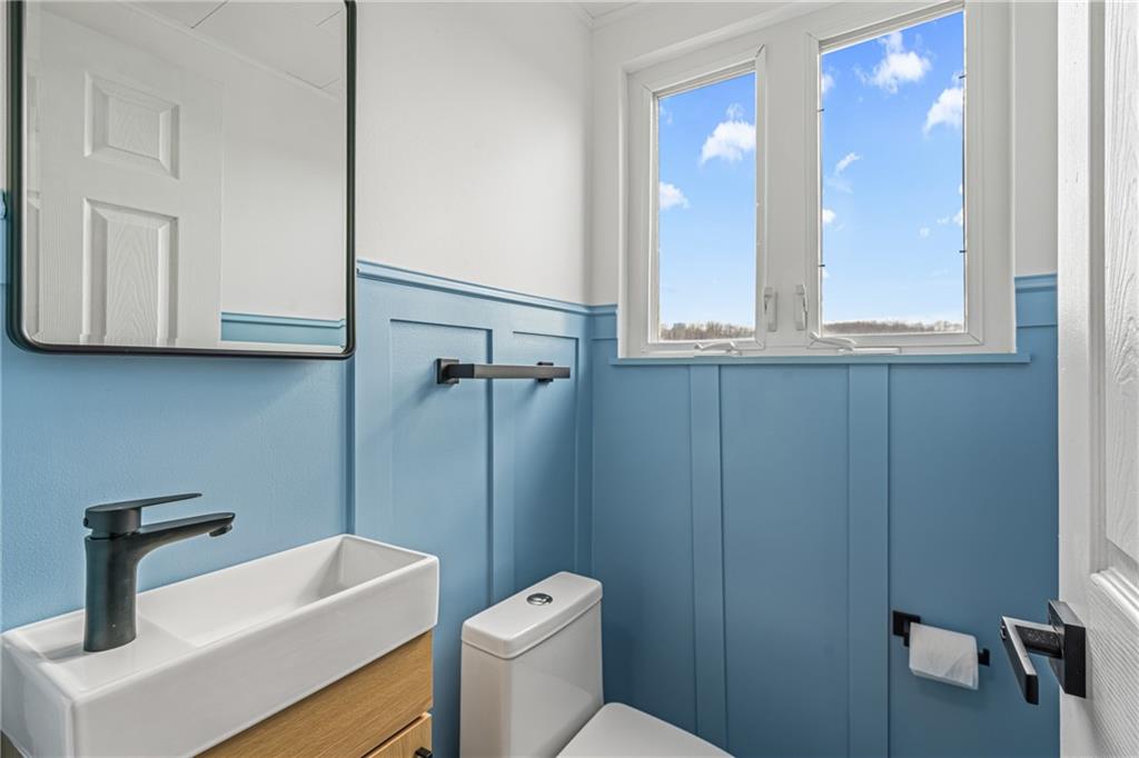 213 Scene Ridge Road McKeesport, PA 15133 - Photo 14 of 22 a bathroom with a toilet a sink and mirror