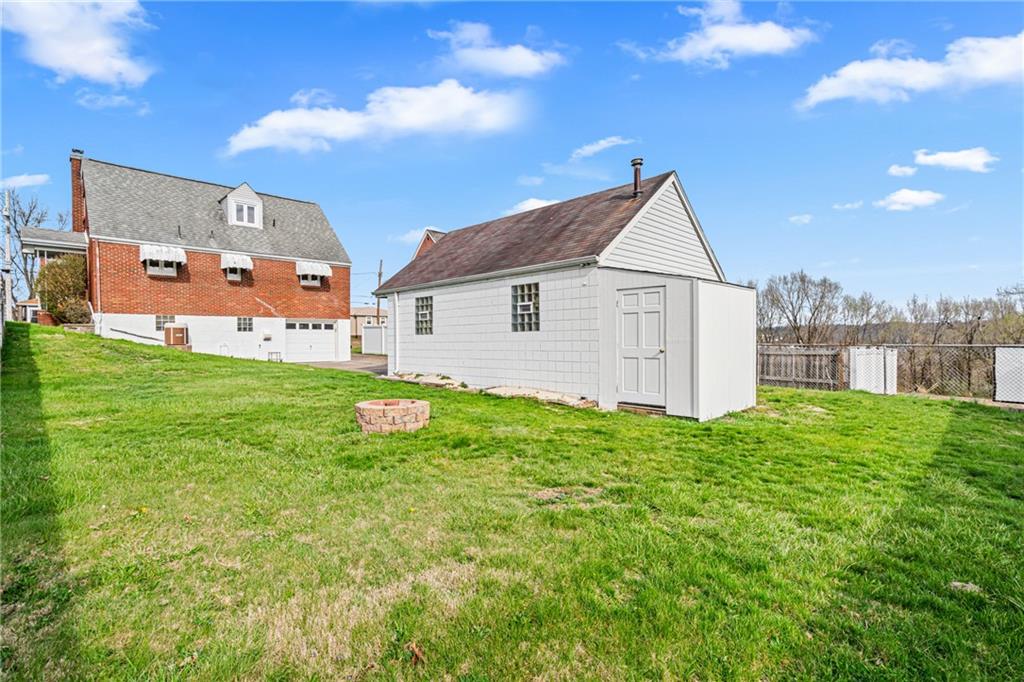 213 Scene Ridge Road McKeesport, PA 15133 - Photo 22 of 22 a view of a backyard with plants and a garden