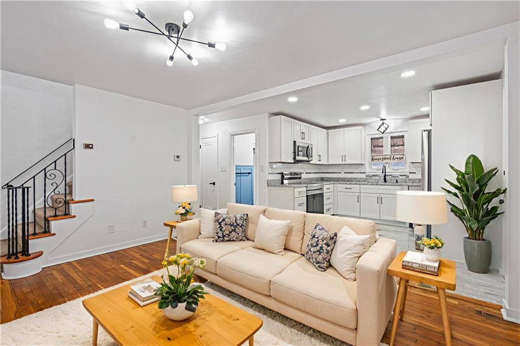 213 Scene Ridge Road McKeesport, PA 15133 - Photo 4 of 22 a living room with furniture kitchen view and a chandelier