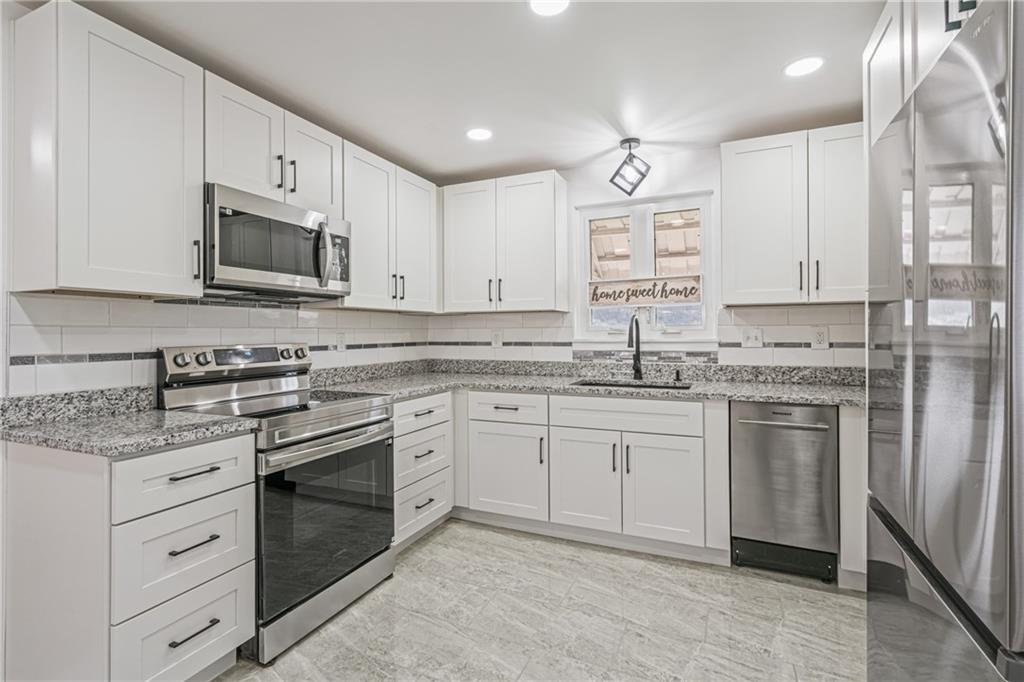 213 Scene Ridge Road McKeesport, PA 15133 - Photo 6 of 22 a kitchen with granite countertop cabinets stainless steel appliances and a sink