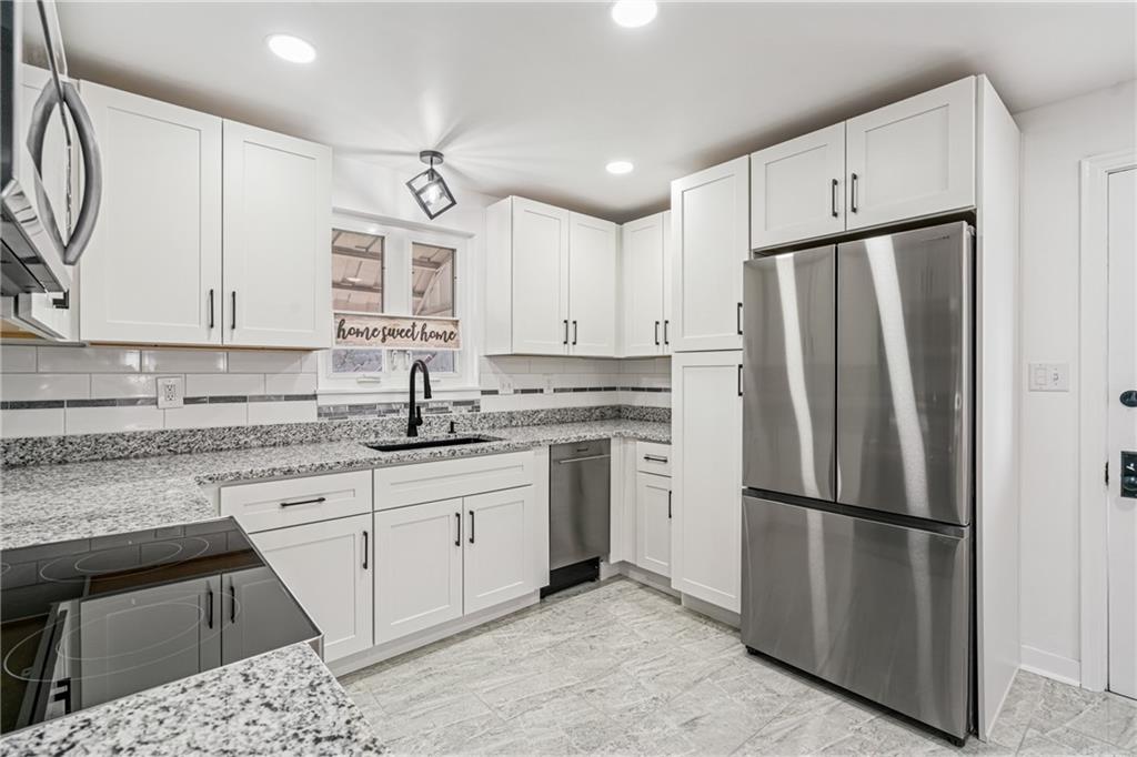 213 Scene Ridge Road McKeesport, PA 15133 - Photo 7 of 22 a kitchen with stainless steel appliances a refrigerator sink and cabinets