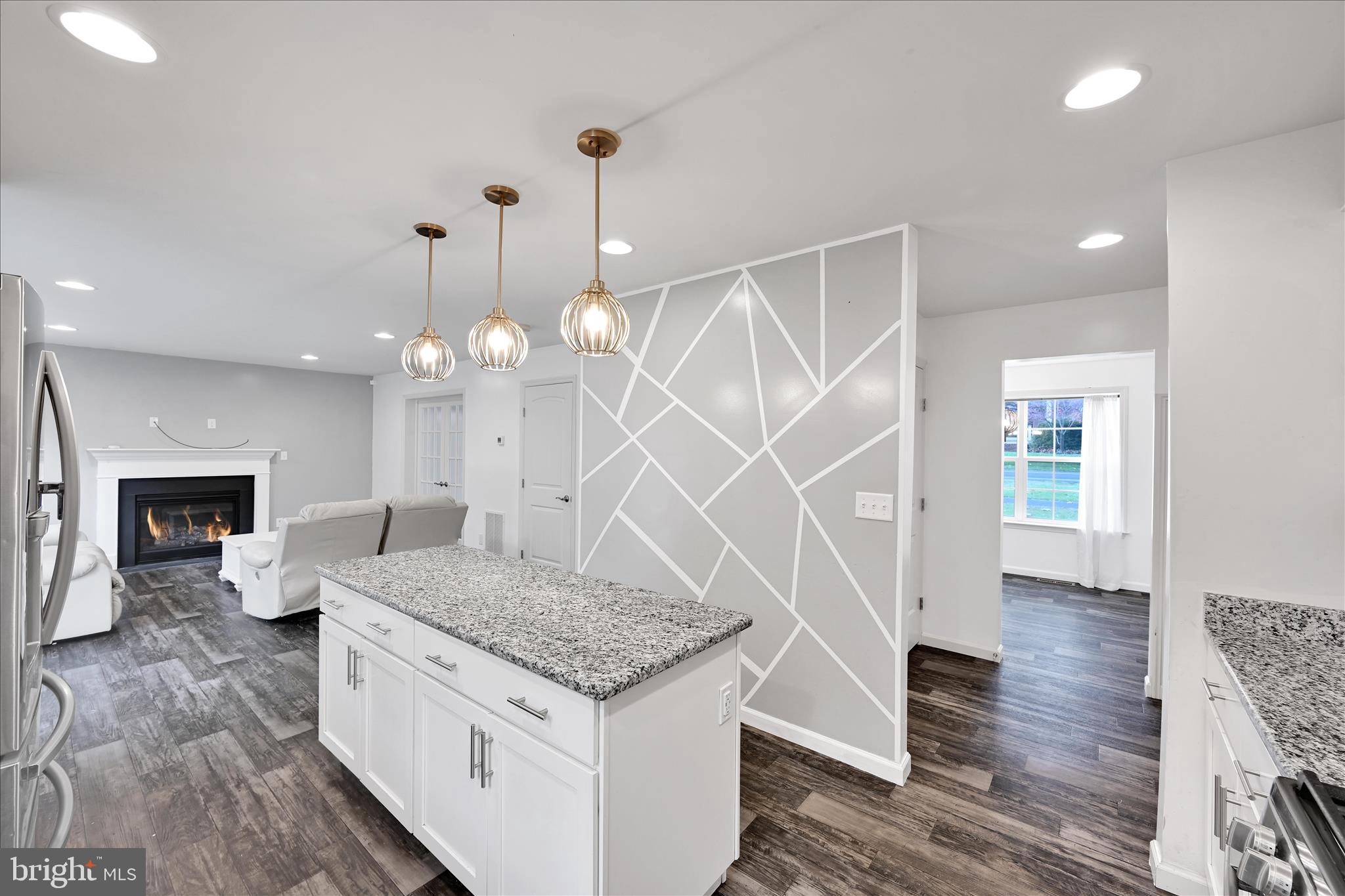 1485 Graystone Road Manheim, PA 17545 - Photo 16 of 43 a kitchen with granite countertop a stove a sink and a wooden floor