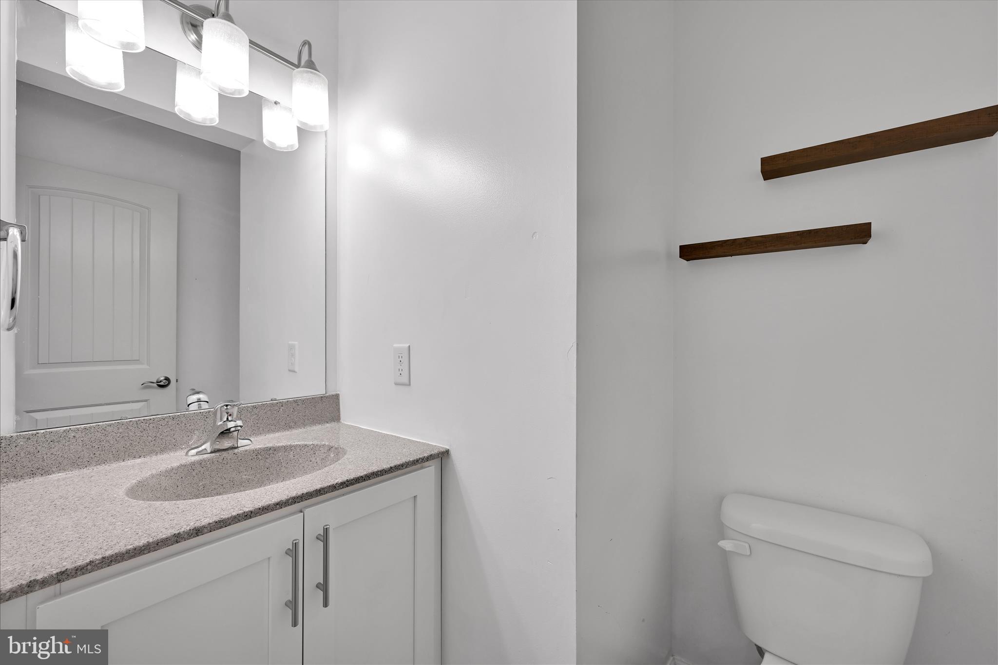 1485 Graystone Road Manheim, PA 17545 - Photo 19 of 43 a bathroom with a granite countertop sink a toilet and a mirror