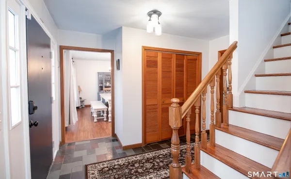 a view of a hallway with wooden floor and stairs