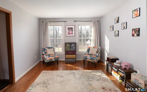 a living room with furniture stairs and a window
