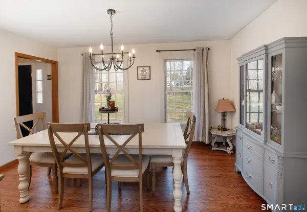 a view of a dining room with furniture window and wooden floor