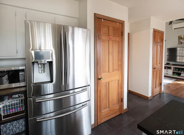 a metallic refrigerator freezer sitting in a kitchen