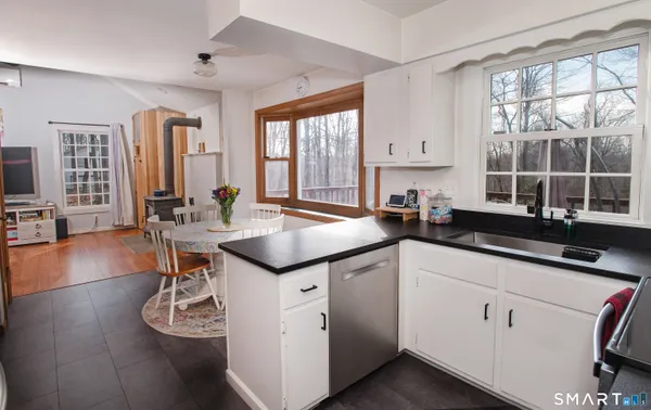 a kitchen with a sink cabinets and window