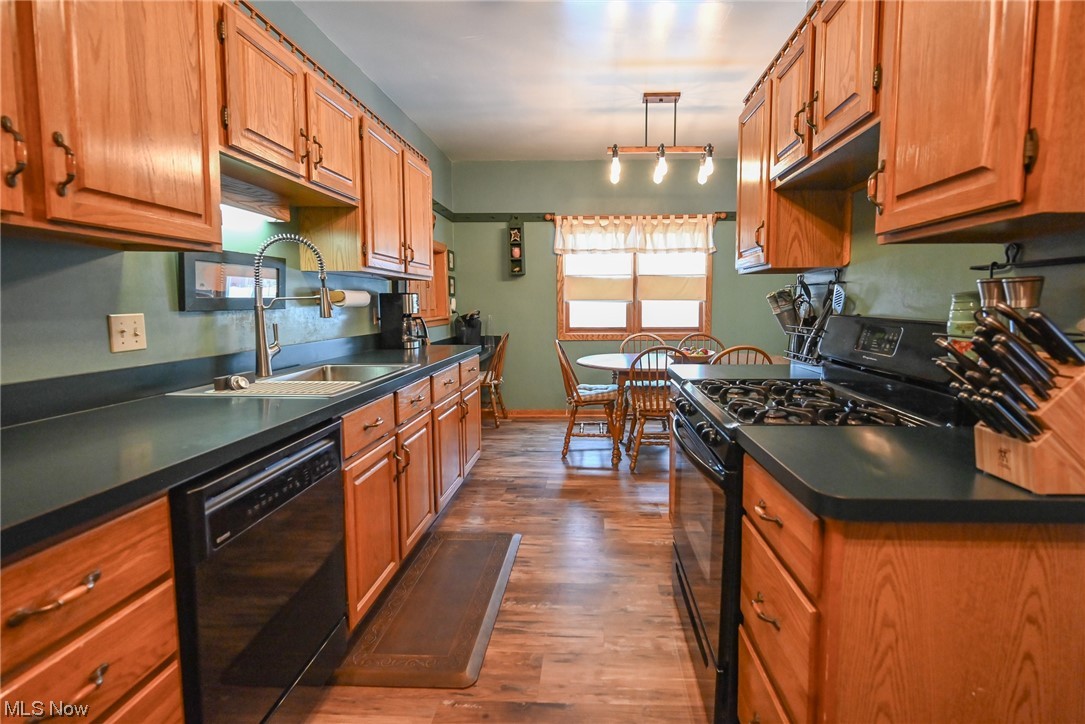 4436 Ridge Road Brooklyn, OH 44144 - Photo 11 of 33 Oak Kitchen with newer flooring, black appliances, and lots of cabinet space