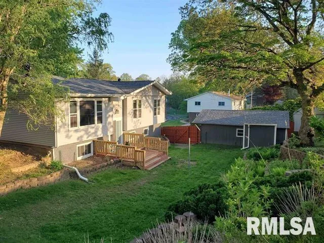 a view of a house with a backyard and a patio