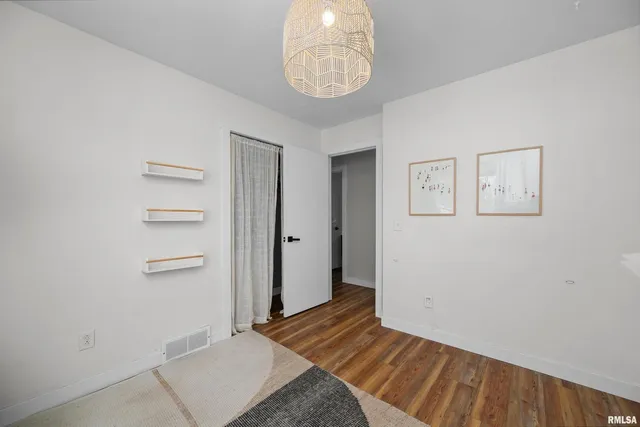 a view of a room with wooden floor and closet