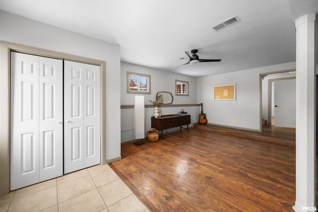 a hallway with wooden floor and furniture