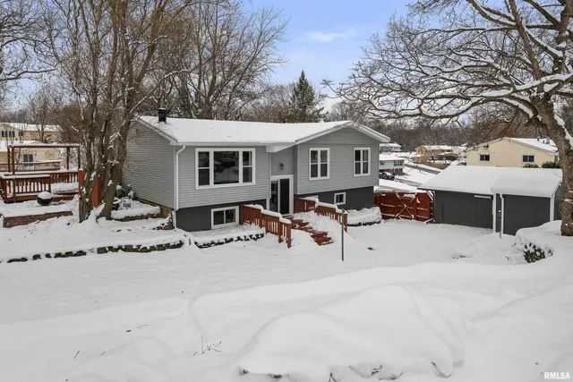 a view of a house with a yard covered in snow