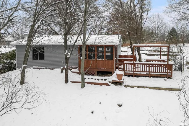 a view of snow on the house with trees