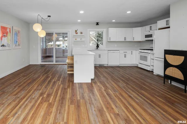a kitchen with stainless steel appliances a refrigerator sink and wooden cabinets